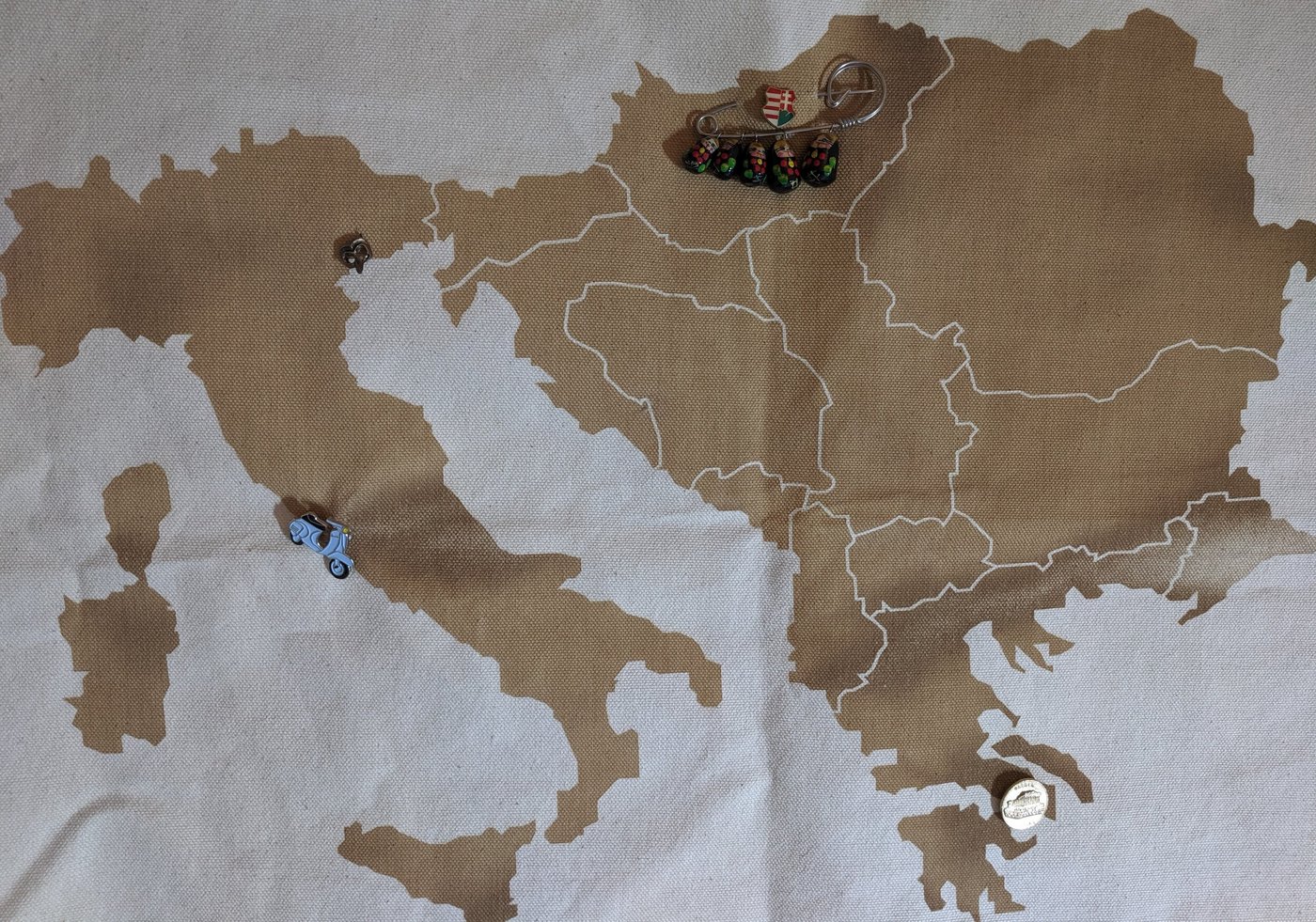 Laser-etched map of central Europe burned into canvas with enamel travel pins attached